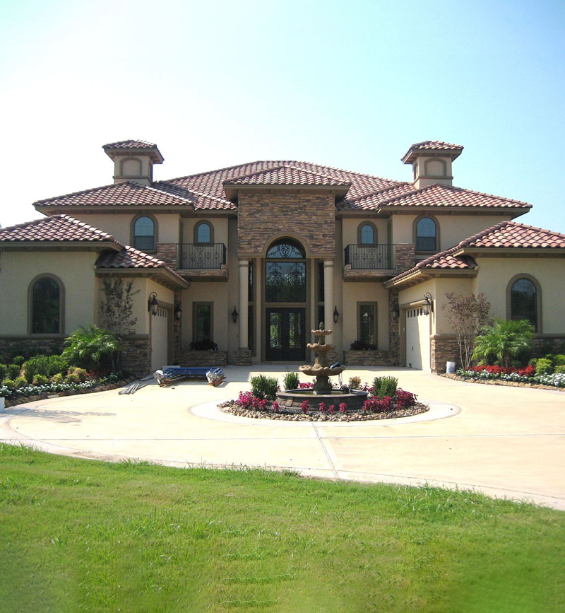 Buy new property A large two-story house with a stone and stucco exterior
